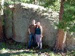 In front of a big rock.